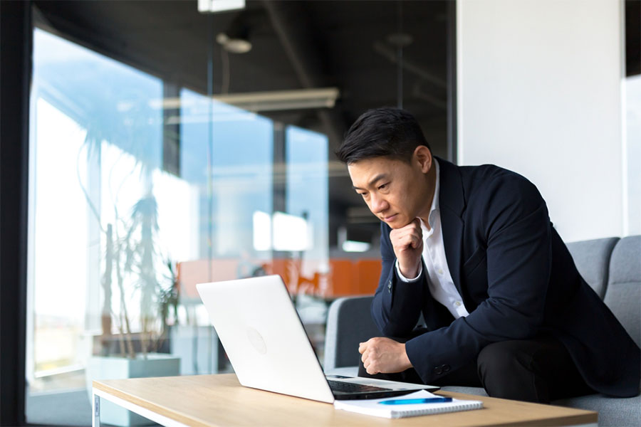 Director pondering over his laptop